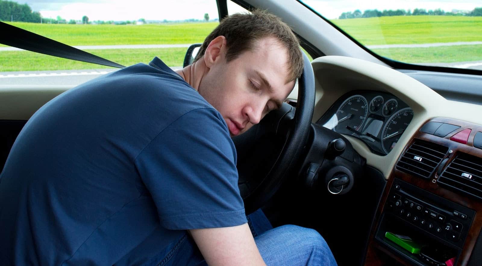 Young Man Sleeps In Car
