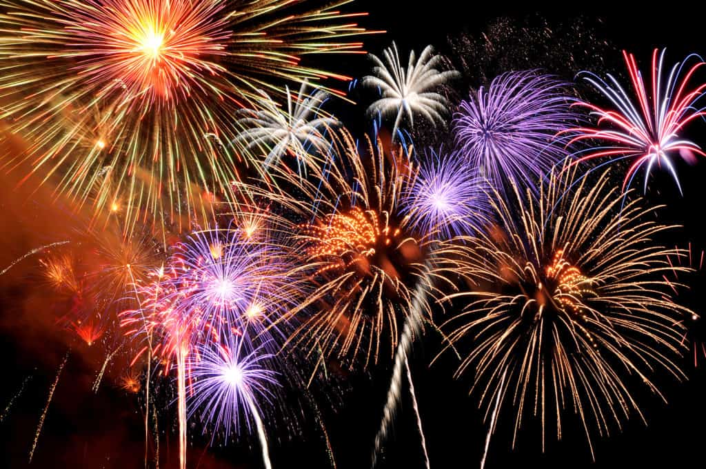Fireworks of various colors bursting against a black background Fireworks of various colors bursting against a black background